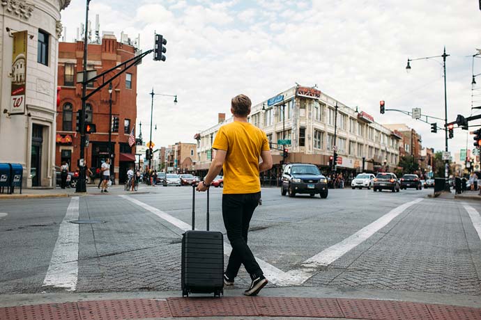 man with suitcase in city